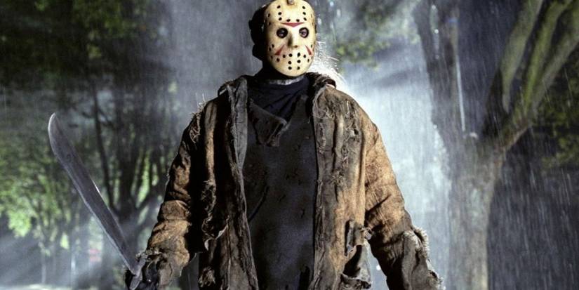 Jason Voorhees, standing in the forest with his mask and machete in Friday the 13th