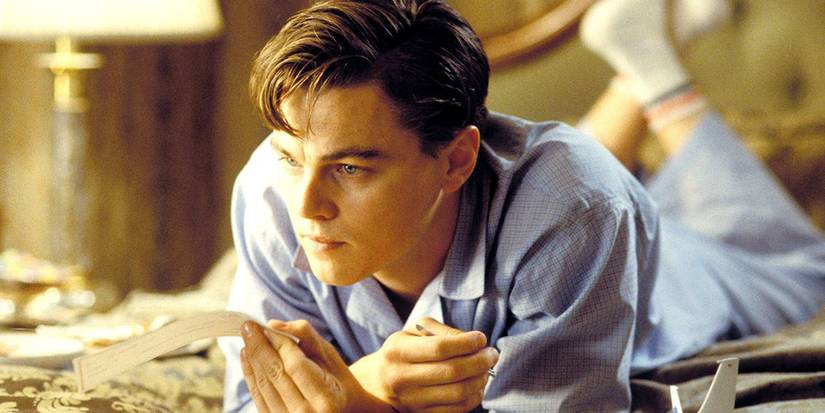 Leonardo DiCaprio as Frank Abegnale Jr lying on a bed holding a fake check in Catch Me If You Can