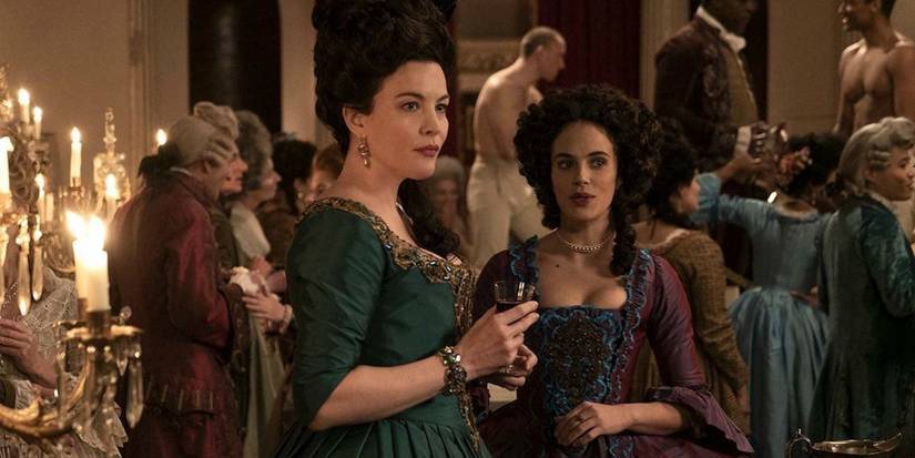 Hulu's Harlots' characters standing around during a party while staring off screen.