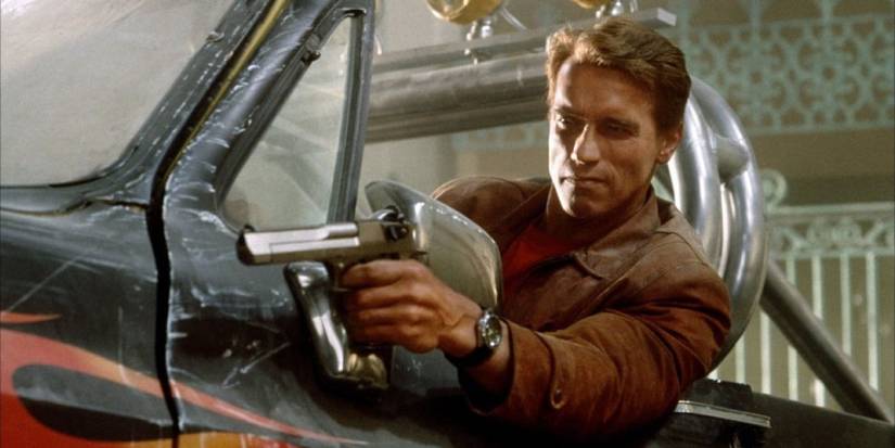 Jack Slater aiming a gun at someone off-camera in Last Action Hero