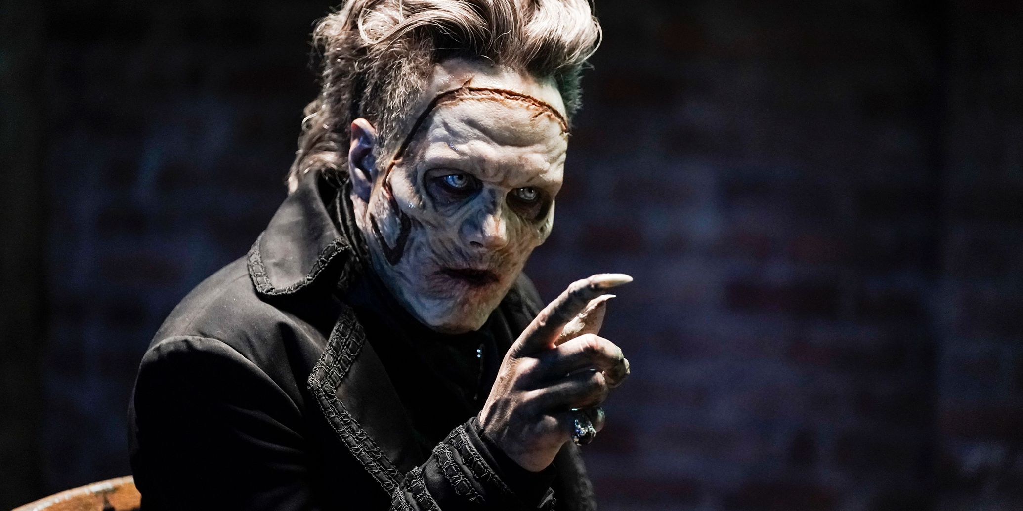 Ben Geurens in Legacies pointing a finger with a ghoulish looking face