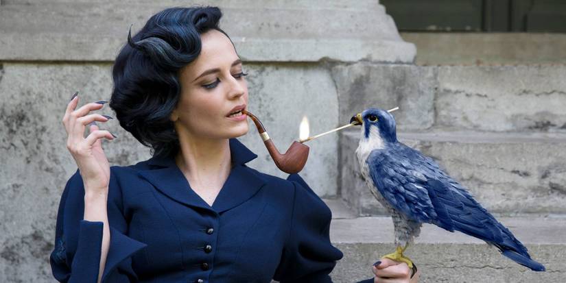 Eva Green as Miss Peregrine with her pipe being lit up by a bird in Miss Peregrine's Home for Peculiar Children.