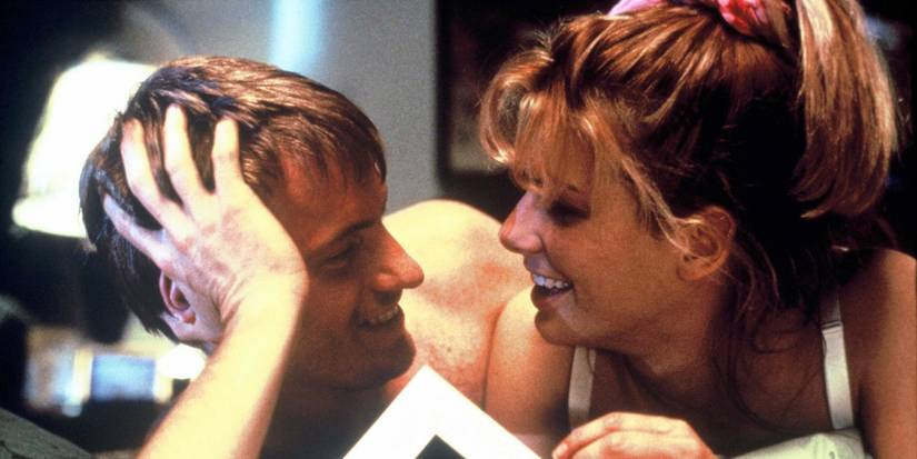 Sandra Bullock lying down and looking at Denis Peary in Two If By Sea