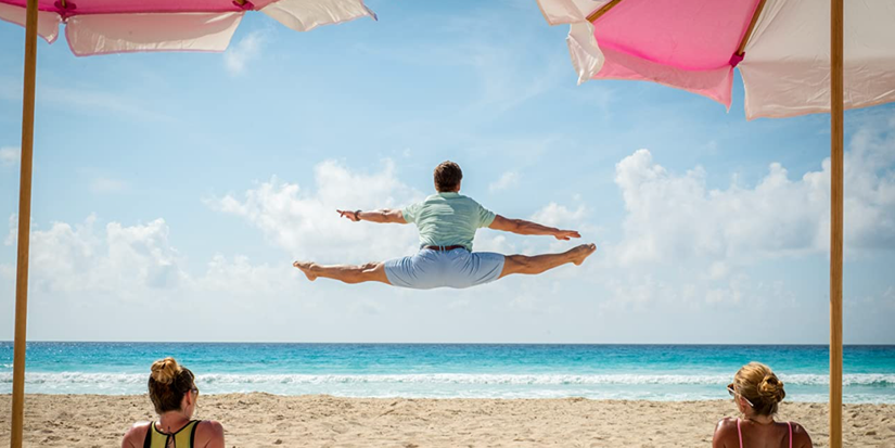 Jamie Dornan as Edgar jumping and doing the splits in Barb and Star Go to Vista Del Mar