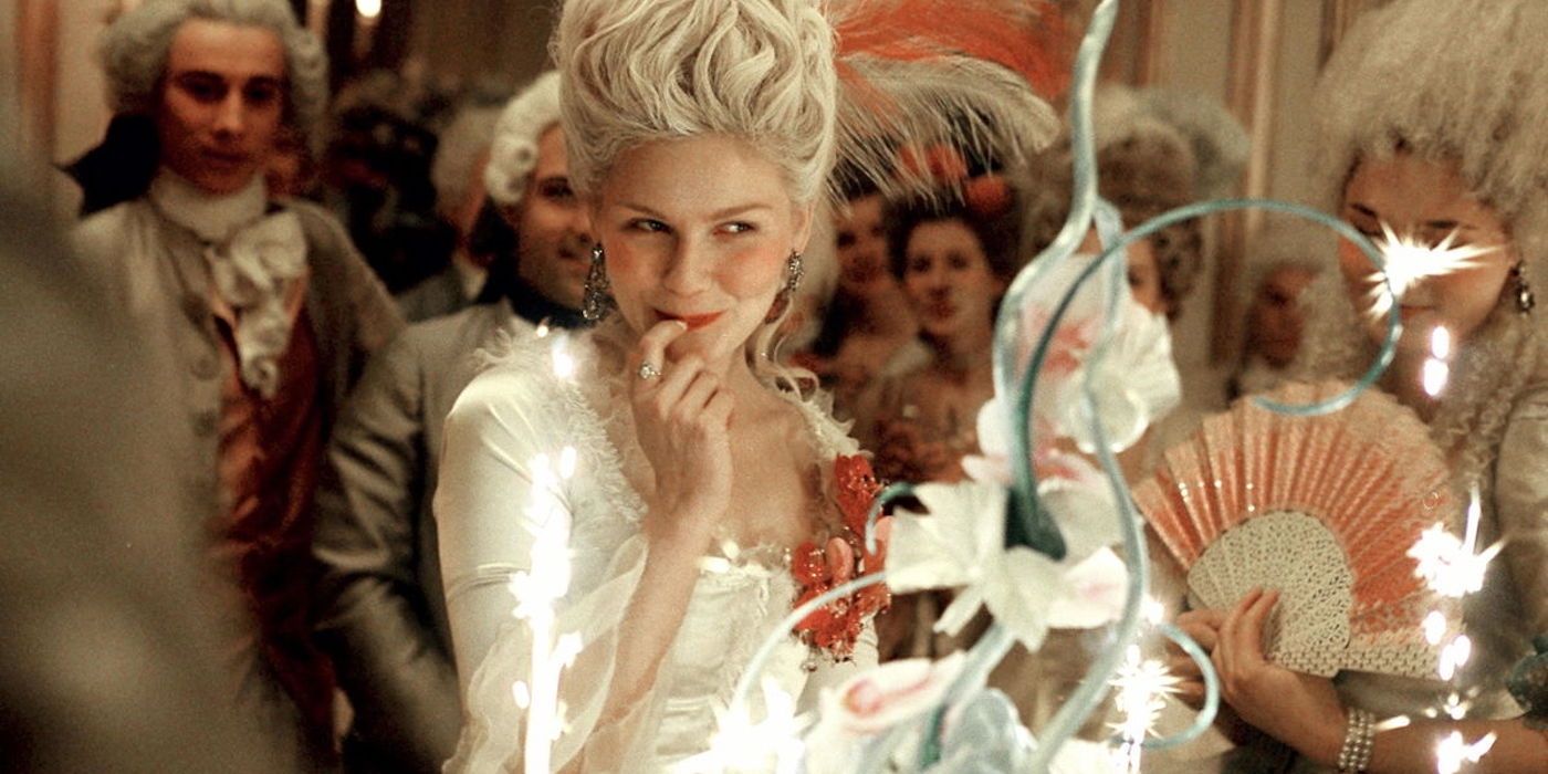Marie Antoinette smiling while licking her finger.