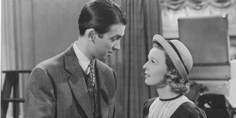 James Stewart and Margaret Sullavan stand together and look at each other in The Shop Around the Corner.