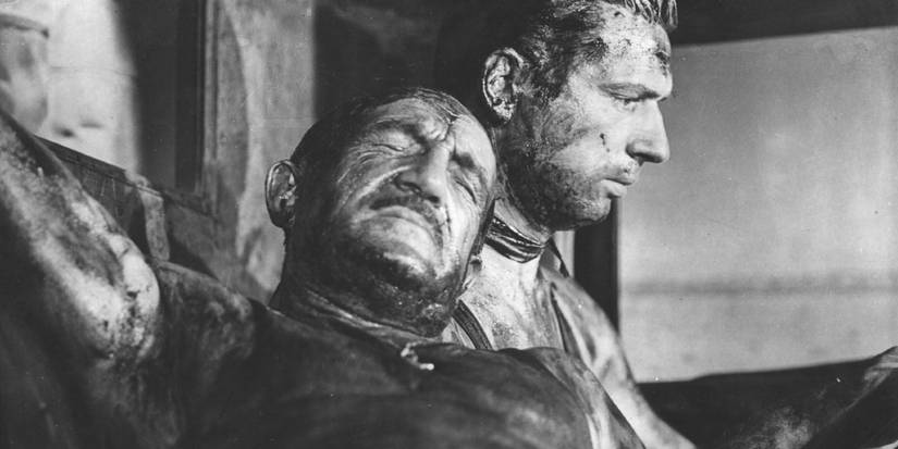 Two bloodied soldiers looking tires in The Wages of War