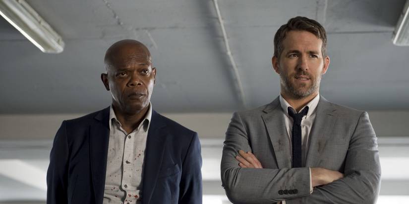 Samuel L Jackson stands next to Ryan Reynolds in The Hitman's Bodyguard.
