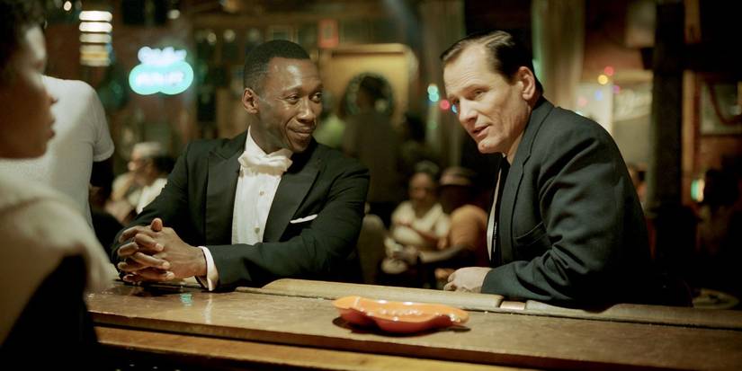 Don Shirley and Tony Lip at a bar, talking to bartender in Green Book