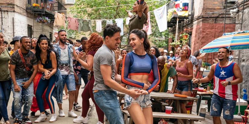 Anthony Ramos and Melissa Barrera dancing with a crowd around them in In the Heights.