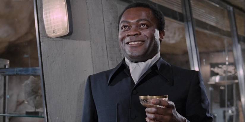 Dr. Kananga grins while holding a glass in 'Live and Let Die'