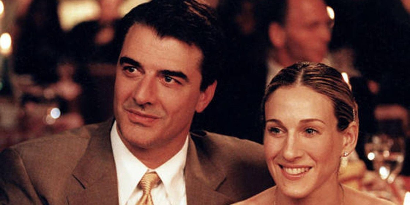 Big and Carrie smiling while at a restaurant in Sex and the City.