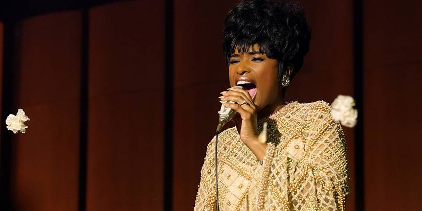 Jennifer Hudson singing into a microphone on stage in Respect, 2021.