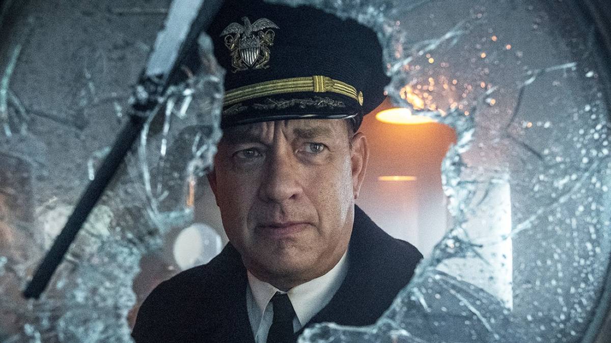 Tom Hanks as Commander Ernie Krause looking out a broken window in Greyhound.