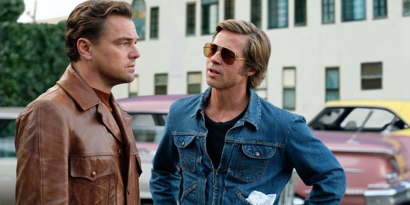 Leonardo DiCaprio and Brad Pitt as Rick Dalton and Cliff Booth, talking outside in Once Upon a Time in Hollywood