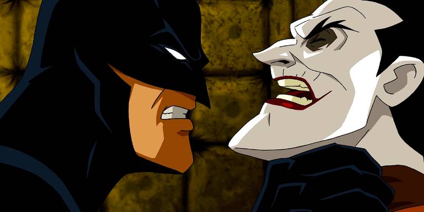 Batman grabs the Joker by the collar and pulls him closer in Batman: Under the Red Hood.