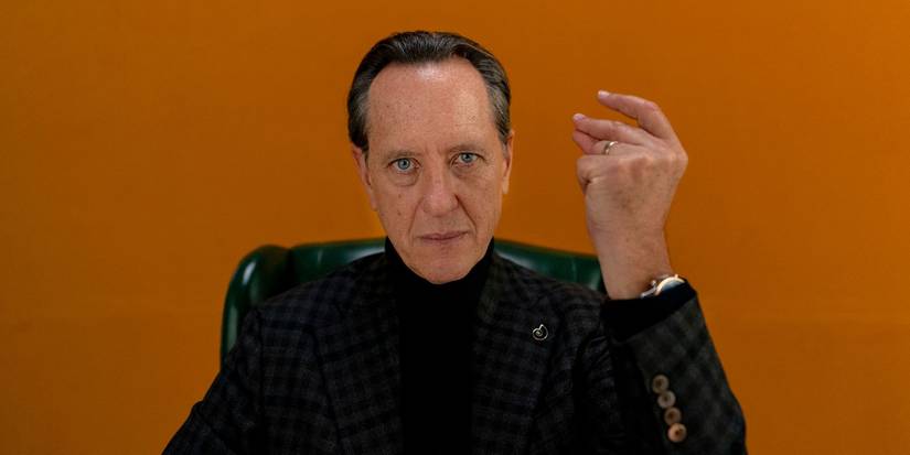 Richard E. Grant in Dispatches from Elsewhere snapping his fingers