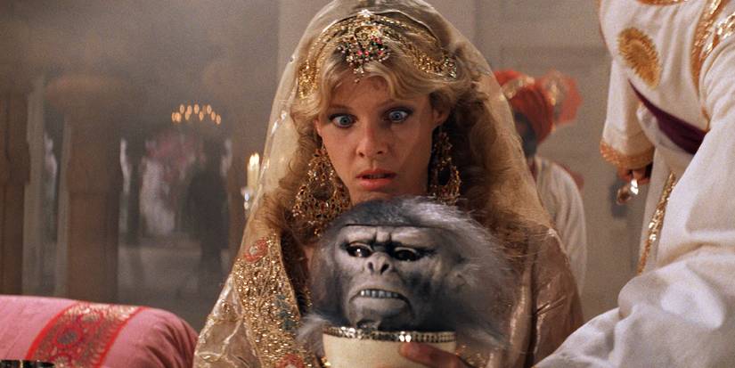 Willie Scott looking at a monkey with a shocked expression in Indiana Jones and the Temple of Doom