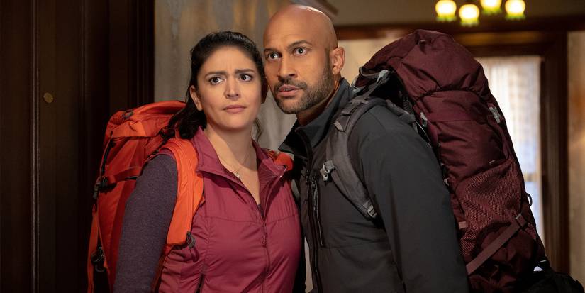 Cecily Strong and Keegan Michael-Key in Schmigadoon! looking at someone off camera.