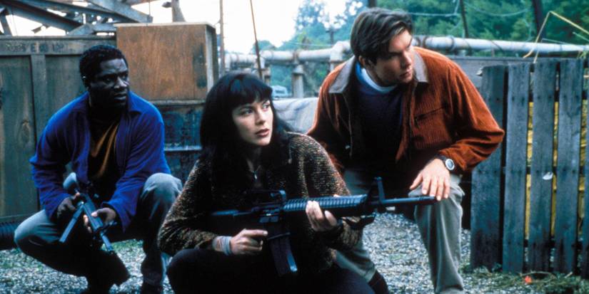 Three young people crouch down with guns in Sliders