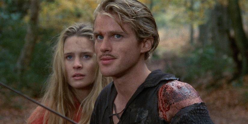 Westley (Cary Elwes) standing protectively in front of Buttercup (Robin Wight) with a bloody injury on his shoulder