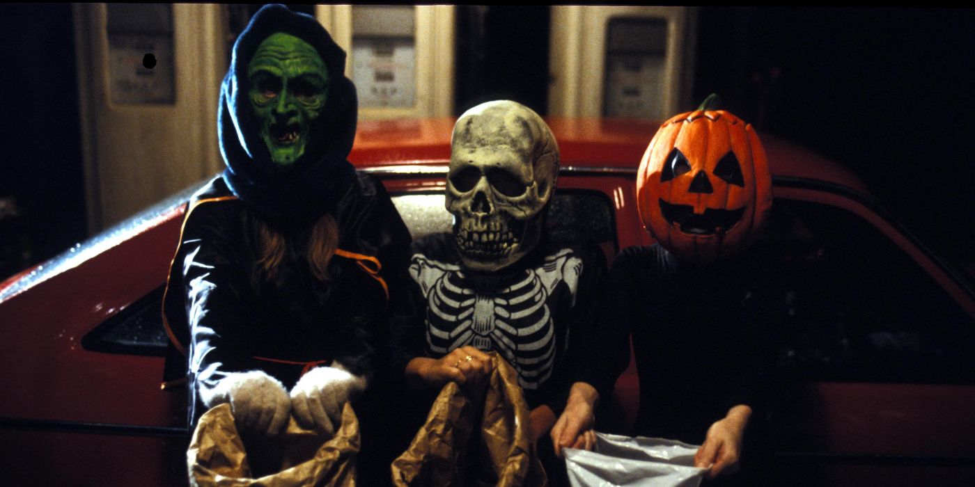 three scary trick-or-treaters sit holding their candy bags in Halloween 3 Season of the Witch