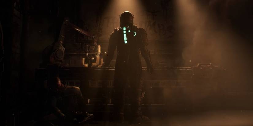 A figure in the shadows stands in the middle of a room in Dead Space