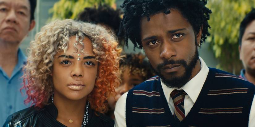 A man and a woman looking intently ahead in Sorry to Bother You