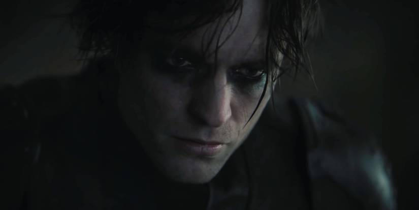 close-up of Robert Pattinson in the batsuit with his mask off, dark circles around his eyes
