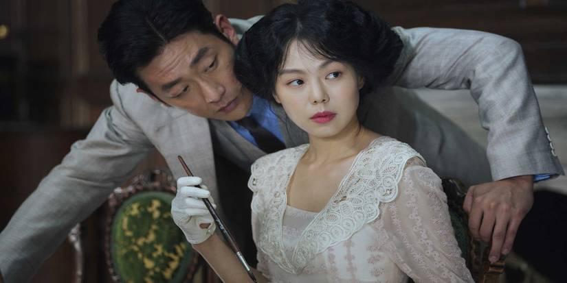 A man leaning next to a young woman in The Handmaiden