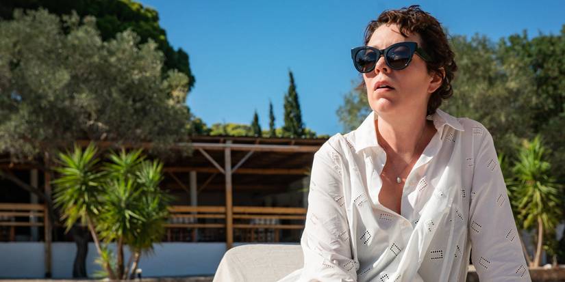 Olivia Colman sits by a swimming pool in The Lost Girl.