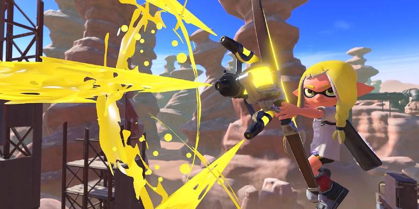 The yellow inkling firing yellow paint from a gun in Splatoon 3