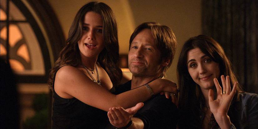 Hank with his daughter and a woman sitting on his lap in Californication.