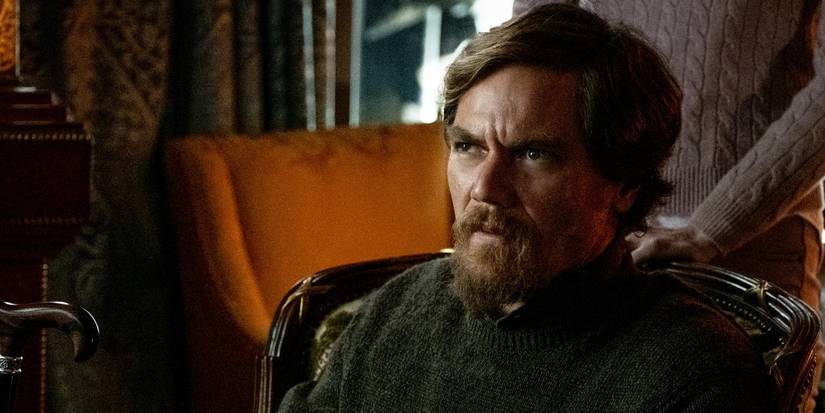 Walt Thrombey sitting down and looking serious in Knives Out