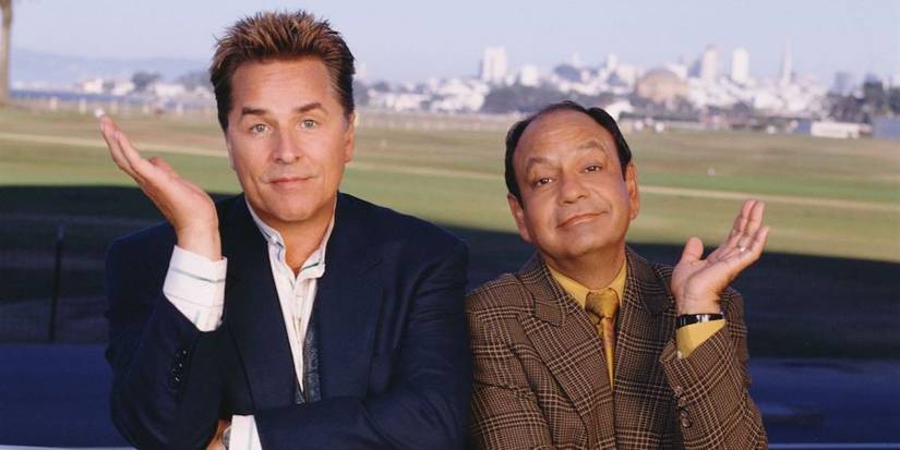 Don Johnson and Cheech Marin posing with their opposite hands up in Nash Bridges.