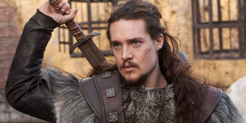 Utred going for the sword strapped to his back in The Last Kingdom