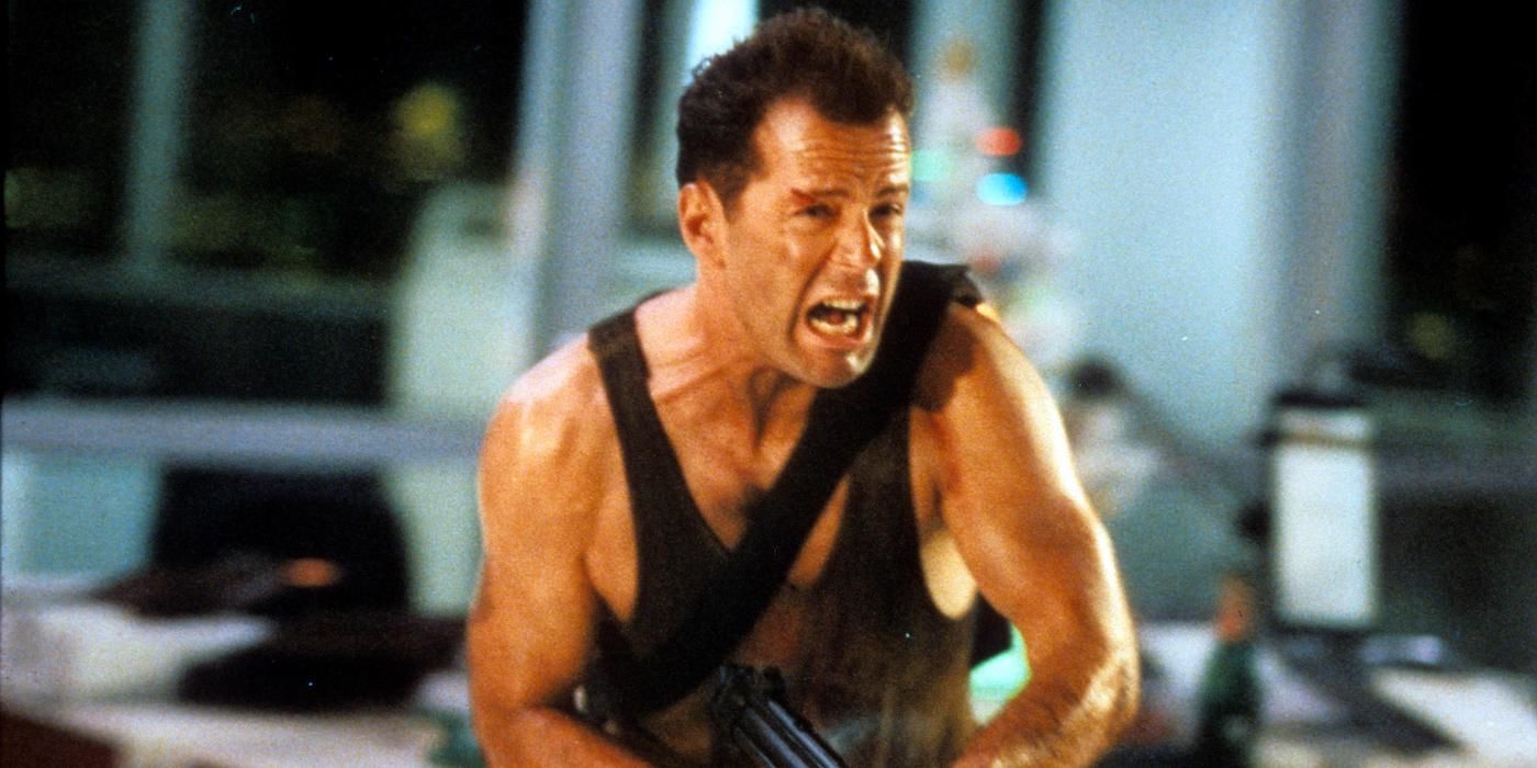 Bruce Willis yelling while wielding a gun in Die Hard