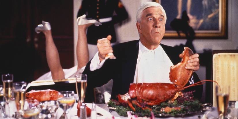 Leslie Nielsen as Frank Drebin eating lobster in 'The Naked Gun 2.'