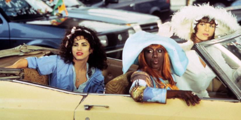 John Leguizamo, Wesley Snipes, and Patrick Swayze as Chi-Chi, Noxeema, and Vida turning to their left from inside a convertible in To Wong Foo Thanks for Everything Julie Newmar