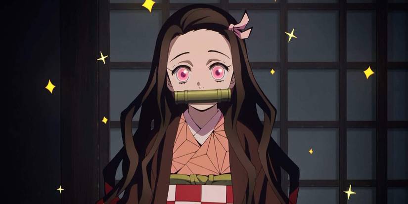 Nezuko Kamado with bamboo in her mouth and stars flying around her in Demon Slayer: Kimetsu no Yaiba.
