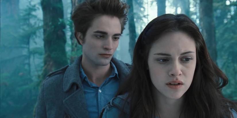 Bella standing closer to the screen, looking concerned, while Edward is standing behind her, looking at the back of her head