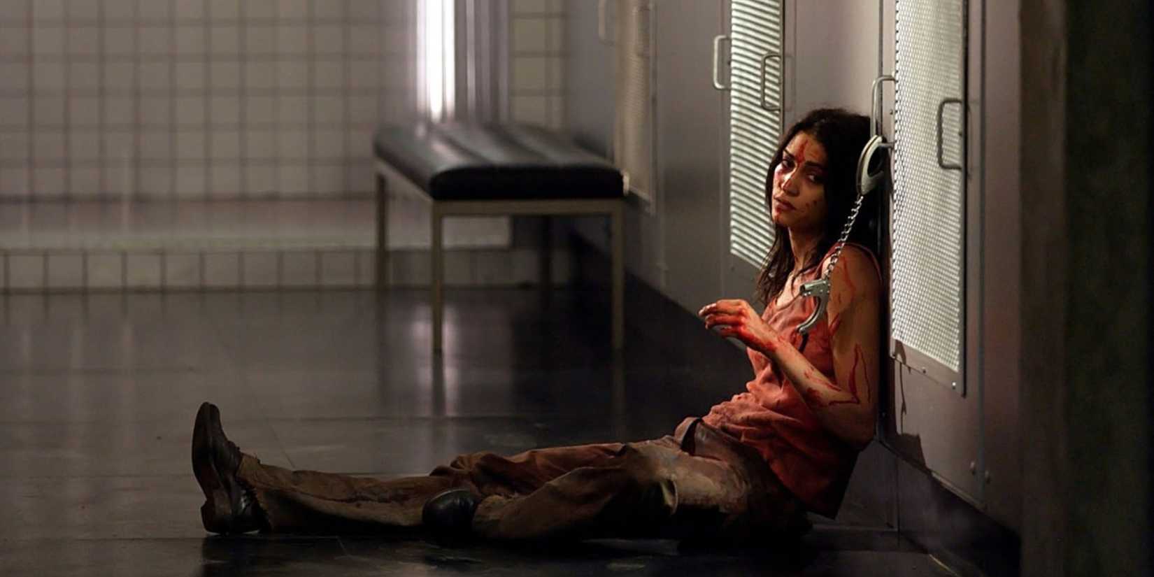 Morjana Alaoui sits handcuffed to a door in Martyrs 