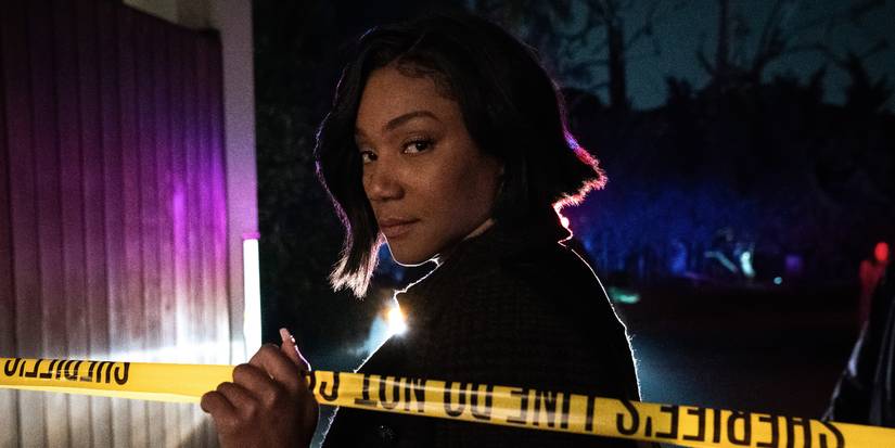 Tiffany Haddish looks over her shoulder at the camera, crossing behind crime scene tape in The Afterparty.