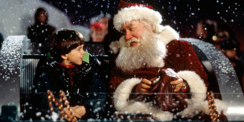 Tim Allen as Scott/Santa and Eric Lloyd as Charlie look at each other in a sleigh in The Santa Clause.