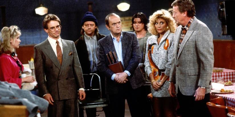 The cast stand in a diner looking like tension and an awkward situation is happening on Newhart.