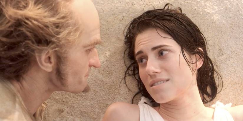 Allison Williams looking at Neil Patrick Harris while laying down on the beach in A Series of Unfortunate Events