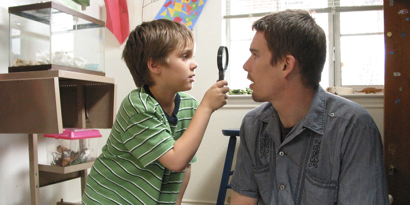 Mason Jr. looking at Mason Sr's face with a magnifying glass in Boyhood (2014).