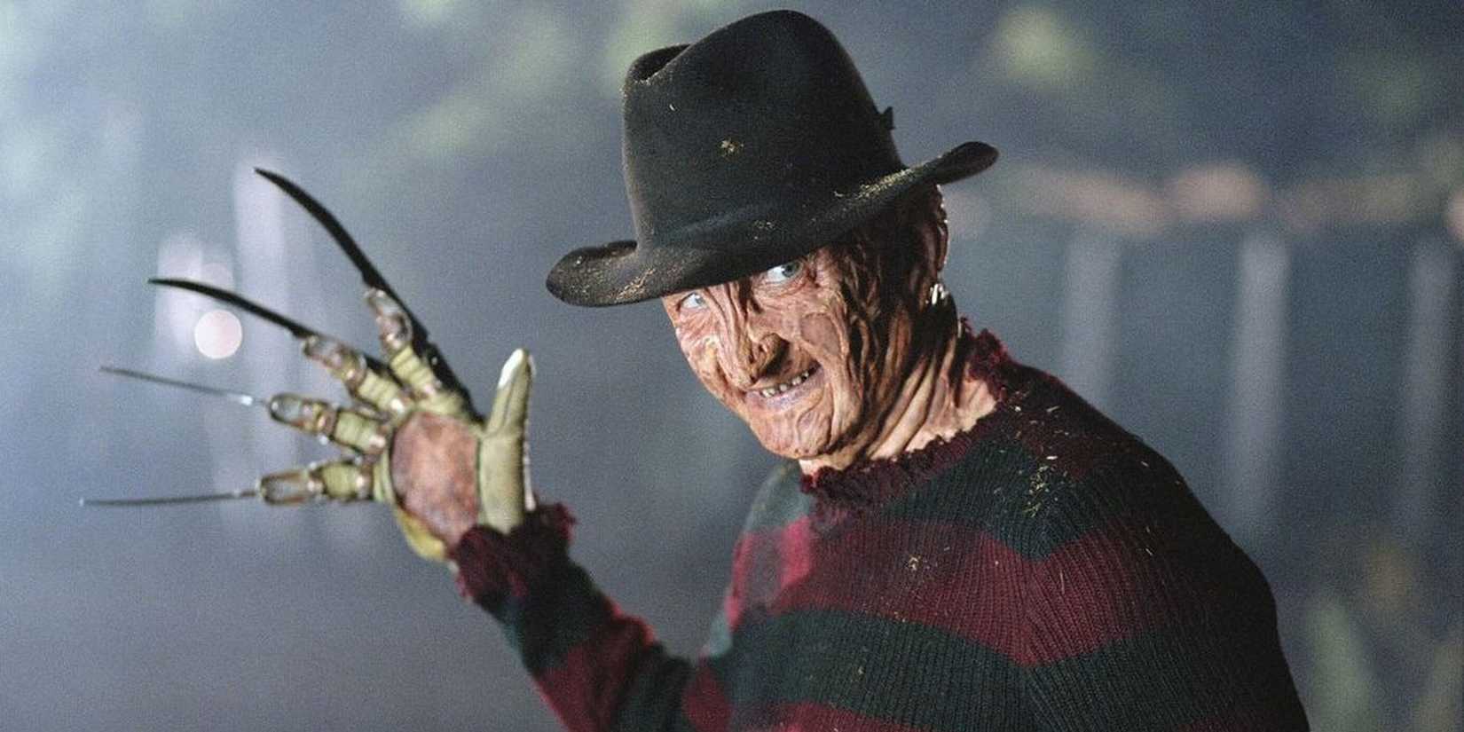 Robert Englund as Freddy Krueger, holding up his bladed glove in A Nightmare on Elm Street