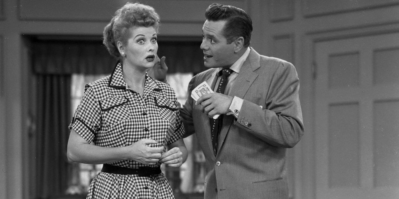 Lucille Ball looks shocked next to Desi Arnaz who holds a wad of cash in 'I Love Lucy'