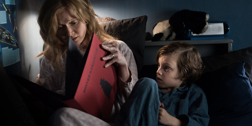 Essie Davis as Amelia reads a children's book called "Mister Babadook" to her son Sam (Noah Wiseman) in 'The Babadook'